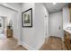 Hallway featuring hardwood floors, white walls, and an artful framed print of vibrant trees at 604 Southland Pass, Canton, GA 30115