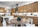 Stylish kitchen with custom cabinets, stainless steel appliances, and a dining table with seating at 604 Southland Pass, Canton, GA 30115