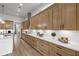 Modern kitchen with sleek wood cabinets, white backsplash, stainless steel appliances, and hardwood floors at 604 Southland Pass, Canton, GA 30115
