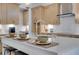Kitchen island with elegant white countertop, seating, and stylish decor at 604 Southland Pass, Canton, GA 30115