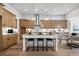 Spacious kitchen with wood cabinets, pendant lighting, a central island, and stainless steel appliances at 604 Southland Pass, Canton, GA 30115