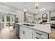 Bright modern kitchen with white cabinets, large island, and stainless steel appliances offers an open layout at 604 Southland Pass, Canton, GA 30115