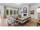 Elegant living room with a brick fireplace, large windows, and stylish seating arrangements at 604 Southland Pass, Canton, GA 30115