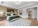 Comfortable main bedroom features neutral paint, tray ceilings, white bedding and unique artwork at 604 Southland Pass, Canton, GA 30115