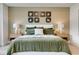 Comfortable main bedroom features neutral paint, white bedding and unique artwork on the wall at 604 Southland Pass, Canton, GA 30115