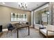 Inviting office with a wood desk, neutral walls, a plush rug, and a large picture window at 604 Southland Pass, Canton, GA 30115