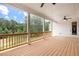Large covered porch with wooden deck and view of the wooded backyard at 604 Southland Pass, Canton, GA 30115