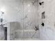 Primary shower has marble walls, a seating bench and a wall mounted shower head at 604 Southland Pass, Canton, GA 30115