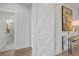 Hallway featuring a decorative sliding door and a view into the bathroom with a glass-enclosed shower at 608 Southland Pass, Canton, GA 30115