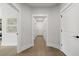 Hallway featuring white trim and doors, leading to other areas of the home at 608 Southland Pass, Canton, GA 30115