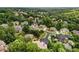 Aerial neighborhood view with lush green trees, showcasing the community's appealing landscaping and street layout at 908 Basingstoke Ct, Suwanee, GA 30024