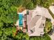 Aerial view of a beautiful home, pool, patio, lush landscaping, and circular driveway at 908 Basingstoke Ct, Suwanee, GA 30024