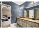 Bathroom with a granite countertop, double sinks, gray walls, and a view into a bedroom at 908 Basingstoke Ct, Suwanee, GA 30024