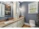 Elegant bathroom with double vanity sinks, granite countertops, and modern lighting fixtures and finishes at 908 Basingstoke Ct, Suwanee, GA 30024