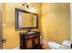 Stylish powder room features an ornate wood vanity and elegant fixtures at 908 Basingstoke Ct, Suwanee, GA 30024