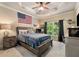 Bedroom with carpet, a ceiling fan, an American Flag on the wall, and a bed with a blue comforter at 908 Basingstoke Ct, Suwanee, GA 30024