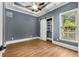 Cozy bedroom with a ceiling fan, wood-look flooring, and a sliding barn door leading to shelving at 908 Basingstoke Ct, Suwanee, GA 30024