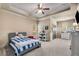 Bedroom with a tray ceiling, carpet, a bed, a window, and decorations on the walls at 908 Basingstoke Ct, Suwanee, GA 30024