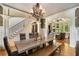 Elegant dining room showcasing modern chandelier, staircase and open layout to living area at 908 Basingstoke Ct, Suwanee, GA 30024
