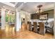 Elegant dining room with hardwood floors, wainscoting, and a view into the living area at 908 Basingstoke Ct, Suwanee, GA 30024