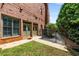 Brick building exterior with private entrance, sidewalk and manicured garden space at 908 Basingstoke Ct, Suwanee, GA 30024