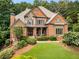 Charming two-story home with a beautifully landscaped front yard and inviting front porch at 908 Basingstoke Ct, Suwanee, GA 30024