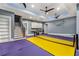 Spacious game room with high ceilings, recessed lighting, multiple ceiling fans, staircase, and ping pong table at 908 Basingstoke Ct, Suwanee, GA 30024