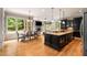 Open concept kitchen offers an island with bar seating, hardwood floors, and stainless steel appliances at 908 Basingstoke Ct, Suwanee, GA 30024