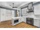 Kitchen featuring granite countertops, white cabinetry, stainless steel appliances, and hardwood floors at 908 Basingstoke Ct, Suwanee, GA 30024