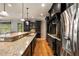 Kitchen with dark cabinets, stainless steel appliances, and hardwood floors at 908 Basingstoke Ct, Suwanee, GA 30024