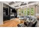 Spacious living room with hardwood floors, fireplace, built-ins and large windows at 908 Basingstoke Ct, Suwanee, GA 30024
