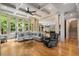 Open-concept living room with hardwood floors, large windows, and a view of the back yard at 908 Basingstoke Ct, Suwanee, GA 30024