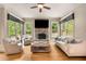 Cozy living room showcases a stone fireplace, hardwood floors, and natural light at 908 Basingstoke Ct, Suwanee, GA 30024