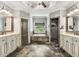 Spacious main bathroom with dual vanities, soaking tub, and glass shower at 908 Basingstoke Ct, Suwanee, GA 30024