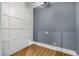 Stylish room featuring paneled accent wall and wood-look floors; perfect for an office, bedroom, or playroom at 908 Basingstoke Ct, Suwanee, GA 30024