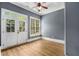 Lovely room with hardwood floors, ample natural light streaming in from French doors and large windows at 908 Basingstoke Ct, Suwanee, GA 30024