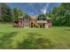 Expansive backyard featuring a brick home, lush green lawn, and outdoor living space at 1041 Flat Rock Rd, Covington, GA 30014