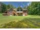 Beautifully maintained backyard featuring a brick home, lush green lawn, and outdoor living space at 1041 Flat Rock Rd, Covington, GA 30014