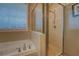 Bright bathroom features a soaking tub and separate glass-enclosed shower, enhanced by natural light at 1041 Flat Rock Rd, Covington, GA 30014