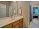 Bathroom features single sink, wood cabinets, and doorways into bedrooms at 1041 Flat Rock Rd, Covington, GA 30014