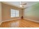 Bright bedroom with a fan, large window, and hardwood flooring at 1041 Flat Rock Rd, Covington, GA 30014