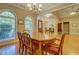 Open dining room features hardwood floors, large windows, and stylish chandelier at 1041 Flat Rock Rd, Covington, GA 30014