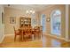 Elegant dining room with hardwood floors, chandelier, and natural light from arched windows at 1041 Flat Rock Rd, Covington, GA 30014