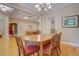 Open-concept dining room with hardwood floors, a large table, and views into the living room at 1041 Flat Rock Rd, Covington, GA 30014
