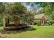 Brick home with well-maintained lawn and landscaping, complemented by mature trees at 1041 Flat Rock Rd, Covington, GA 30014