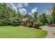 Charming brick home with a well-manicured lawn and mature trees offers great curb appeal at 1041 Flat Rock Rd, Covington, GA 30014