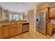 Bright kitchen featuring stainless steel appliances, wooden cabinets, and an adjacent breakfast area at 1041 Flat Rock Rd, Covington, GA 30014