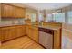 Well-lit kitchen showcasing stainless steel appliances, wooden cabinetry, and granite countertops at 1041 Flat Rock Rd, Covington, GA 30014