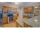 Modern kitchen featuring granite countertops, stainless steel appliances, and wood cabinets at 1041 Flat Rock Rd, Covington, GA 30014