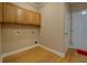 Utility room features hardwood floors, overhead cabinets, and washer/dryer hookups at 1041 Flat Rock Rd, Covington, GA 30014